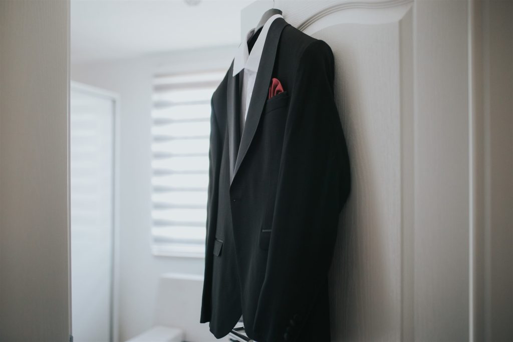Black suit and white shirt on a hanger
